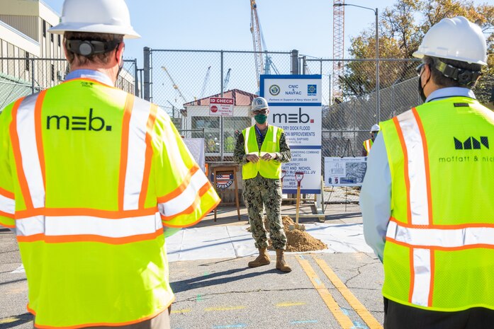 Norfolk Naval Shipyard (NNSY), RDML Howard Markle, addressed contractors and the NNSY workforce during a groundbreaking ceremony for its Dry Dock Floodwall Protection Improvements Project Nov. 4. The $43.6 million project will protect the small docks and their associated facilities, infrastructure, and equipment from flooding from the Elizabeth River.  This project is a part of the Shipyard Infrastructure Optimization Program (SIOP), a 20-year, $21 billion program dedicated to completely refurbishing the nation’s four public shipyards by modernizing equipment, improving workflow and upgrading dry docks and facilities.