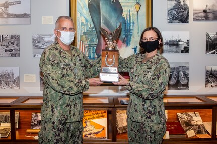 Capt. Dan Rossler presents the Silver Eagle trophy to Capt. Heather Wilson, the first female LDO to be presented the award.