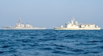 Guided-missile destroyer USS John Paul Jones (DDG 53), left, conducts a passing exercise with the Royal Bahrain Naval Force ship Al Manama (P 50) in the Arabian Gulf, Oct. 27. John Paul Jones is part of the Nimitz Carrier Strike Group, deployed to the U.S. 5th Fleet area of operations, and currently supporting Coalition Task Force Sentinel, the operational arm of the International Maritime Security Construct, to ensure maritime security and stability in the critical waterways of the Central region. (U.S. Navy photo by Mass Communication Specialist 3rd Class Aja Bleu Jackson)