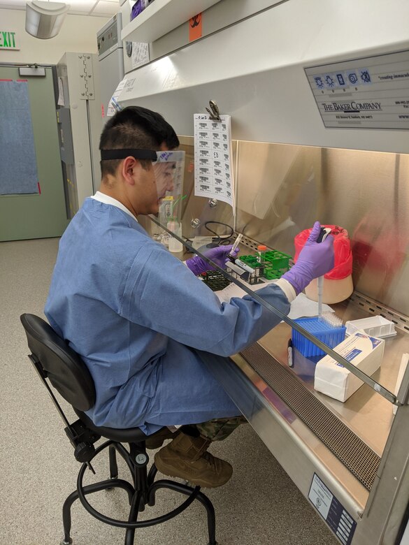 Alaska Air National Guard Capt. Roger Tran, the Nuclear Medical Science Officer for the 103rd Civil Support team, tests COVID-19 samples at the Alaska State Public Health laboratory on June 8, 2020. From early June, to mid-August, Tran augmented the Alaska State Public Health laboratory, working closely with state microbiologists, processing COVID-19 samples for testing. Over the course of approximately 21 days of testing, totaling more than 148-man hours, the two officers tested 11,426 samples. (U.S. Army National Guard courtesy photo by Capt. Jamie Bowden)