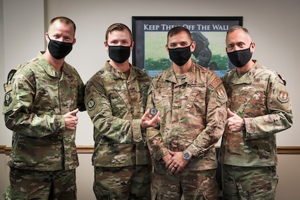 Tech. Sgt. Tim Donnan, (center left) is congratulated by Commander, Air Force Installation and Mission Support Center Maj. Gen Tom Wilcox, (far right), during Wilcox’s visit to NSWC IHD, Nov. 5. Wilcox visited the command to recognize the Air Force Civil Engineer Center’s Joint Explosive Ordnance Disposal Technology Division on their recent nomination for a Gears of Government Award. Also pictured are Chief Master Sgt. Edwin V. Ludwigsen (far left) and Maj. Patrick Kucera (center right). (U.S. Navy photo by Matt Poynor)