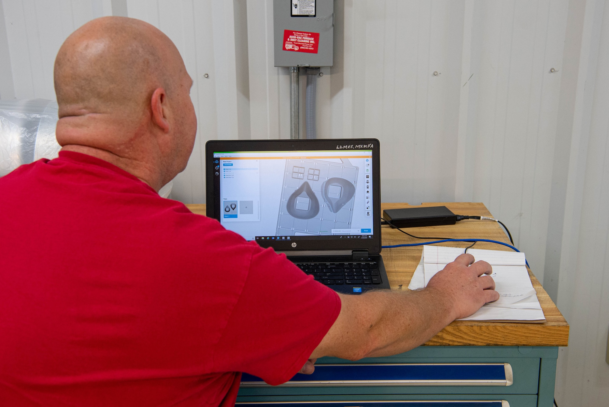 Robert Hogsett, 62nd Maintenance Squadron Metals Technology Shop 3D printer technician, adjusts the original design for a face mask to be 3D printed at Joint Base Lewis-McChord, Wash., Sept. 9, 2020. Hogsett and a fellow coworker fine-tuned a prototype for the mask to be used by the 62nd Medical Squadron dental section to keep the safe during the COVID-19 pandemic. (U.S. Air Force photo by Senior Airman Tryphena Mayhugh)