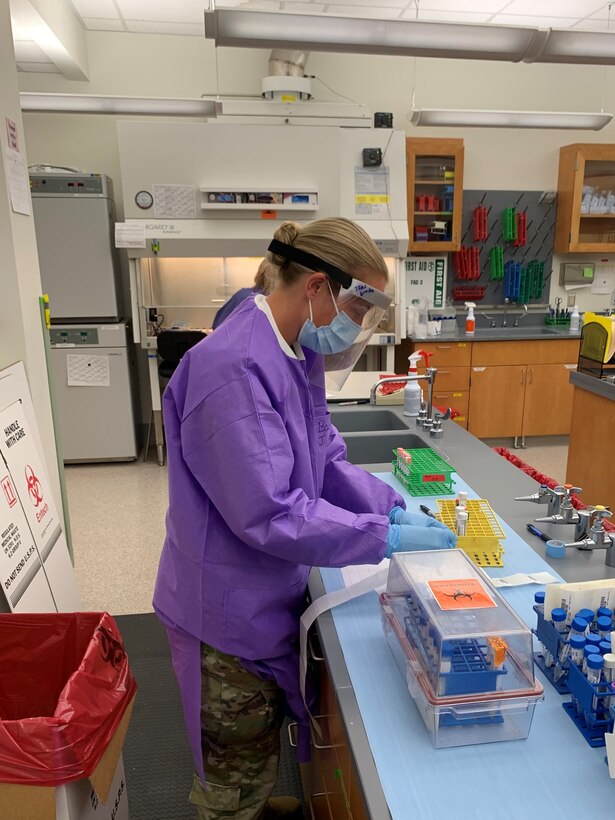 Alaska Army National Guard Capt. Jamie Bowden, who specializes in medical operations for the 103rd Civil Support team, tests COVID-19 samples at the Alaska State Public Health laboratory on June 8, 2020. Bowden augmented the Alaska State Public Health laboratory, working closely with state microbiologists, processing COVID-19 samples for testing. Over the course of approximately 21 days of testing, totaling more than 148-man hours, the two officers tested 11,426 samples. (U.S. Air National Guard courtesy photo by Capt. Roger Tran)