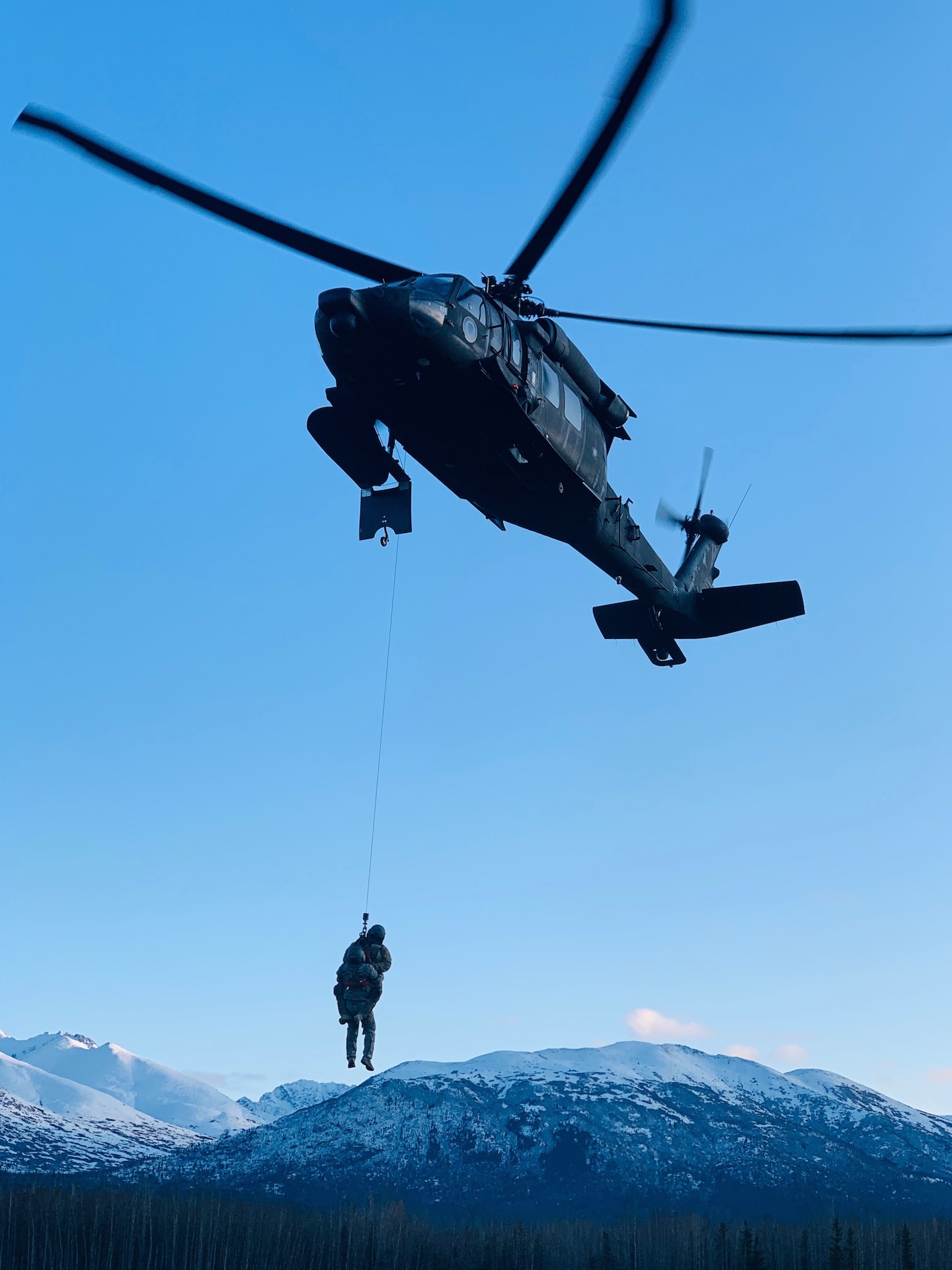 Members of the Alaska Army National Guard's 207th Aviation Regiment, led by Chief Warrant Officer Two Paul Gillquist, conduct hoist training on Joint Base Elmendorf-Richardson in the winter, Feb. 20, 2020. Gillquist recently performed his first real-world rescue mission near the village of Tyonek on Sept. 13, 2020.. (Courtesy photo)