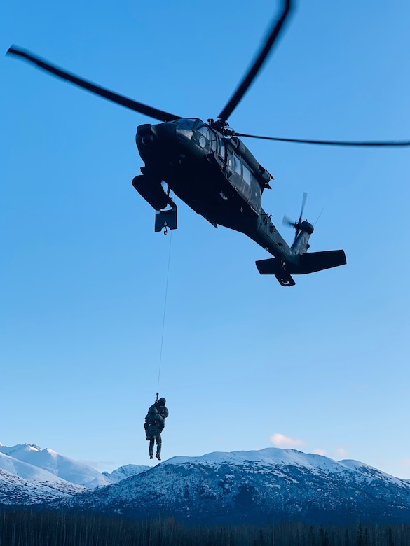 Members of the Alaska Army National Guard's 207th Aviation Regiment, led by Chief Warrant Officer Two Paul Gillquist, conduct hoist training on Joint Base Elmendorf-Richardson in the winter, Feb. 20, 2020. Gillquist recently performed his first real-world rescue mission near the village of Tyonek on Sept. 13, 2020.. (Courtesy photo)