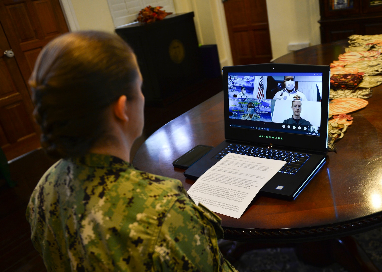 Capt. Ann McCann, commodore of Destroyer Squadron 7, listens to opening remarks during a virtual opening ceremony for Cooperation Afloat Readiness and Training (CARAT) Bangladesh 2020.