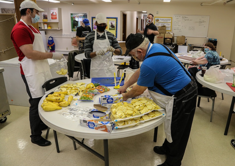 Alaska Air National Guardsmen Tech Sgt. Brayden Van Bevera and Tech Sgt. Allen Wilson work alongside head chef Mike Gor-don at the Five Loaves, Two Fish Kitchen in Wasilla, Alaska, Sept. 22, 2020. The Airmen have worked with the dedicated kitch-en staff since mid-August, pre-paring fresh, cooked meals for Alaska residents in need. The kitchen provides meals to My House Homeless Teens Resource Center, Knik House and Family Promise. (U.S. Army National Guard photo by Sgt. Seth LaCount/Released)