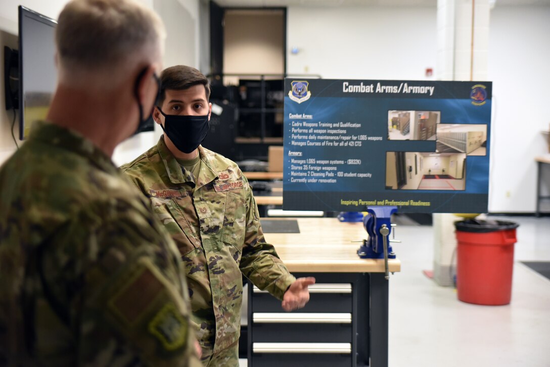 Tech. Sgt. Christian McGinnis, Noncommissioned Officer in Charge, Armory, 421st Combat Training Squadron, provides a briefing on armory operations, highlighting the recent improvements to the armory to Maj. Gen. Mark Camerer, U.S. Air Force Expeditionary Center commander, during his immersion tour with the U.S. Air Force Expeditionary Operations School at Joint Base McGuire-Dix-Lakehurst, New Jersey on Oct. 20, 2020.  Airmen at the USAF EOS campus explained how they contribute to the USAFEC, Air Mobility Command, and Air Force missions to Camerer who recently took command of the USAFEC. (U.S. Air Force photo by Maj. George Tobias)