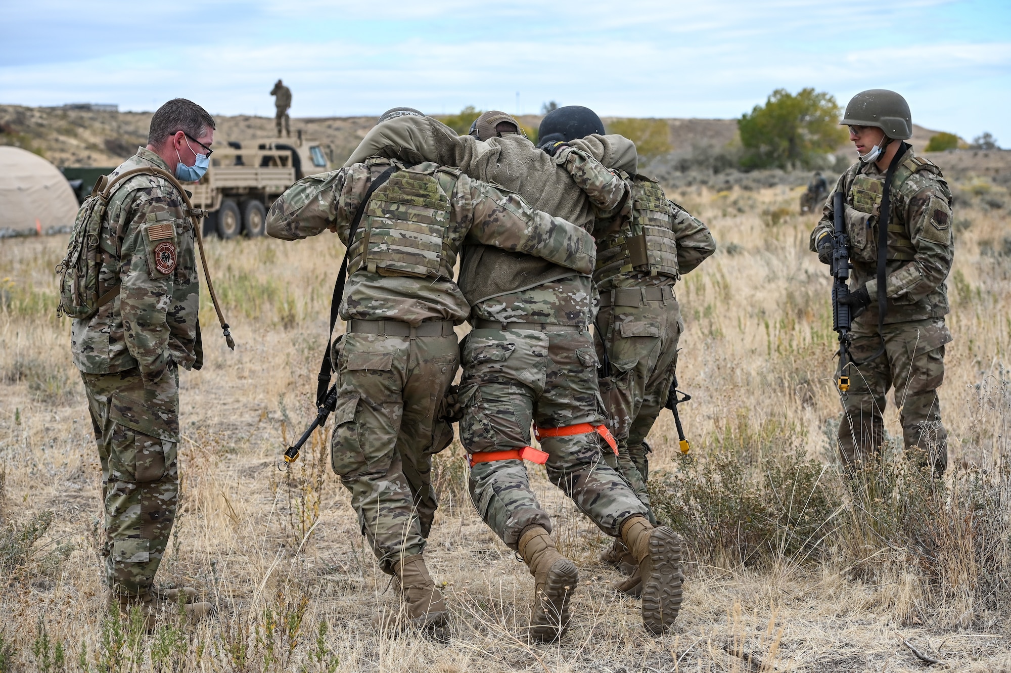 Airmen drag a simulated wounded Airman during a Deployment Initial Readiness Training, or DIRT, exercise Oct. 22, 2020, at Hill Air Force Base, Utah. Airmen from 729th ACS, along with their sister unit 726th ACS, participated in the 48-hour training exercise where they were taught deployment readiness skills. (U.S. Air Force photo by Cynthia Griggs)
