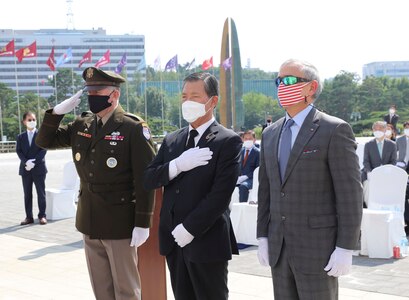 Gen. Robert B. “Abe” Abrams, commander of United Nations Command, ROK-US Combined Forces Command, and United States Forces Korea, U.S. Ambassador to Korea Harry Harris, and Korean American Friendship Society director Hwang Jin Ha place a flower at the stone base of the U.N. Memorial as a tribute to service members who paid the ultimate sacrifice during the Korean War.