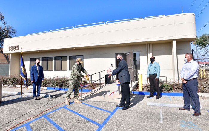 From left: Naval Surface Warfare Center, Port Hueneme Division (NSWC PHD) NSWC PHD Technical Director Paul Mann, Commanding Officer Capt. Andrew Hoffman, Air Dominance Department Director Mike Horton, PHD Facilities Project Manager James Thompson and Mark Vaca Sr., president of OCS Construction Services, celebrate the Nov. 4 ribbon cutting of the refurbished Building 1385. OCS Construction Services completed the work under the supervision of the U.S. Army Corps of Engineers