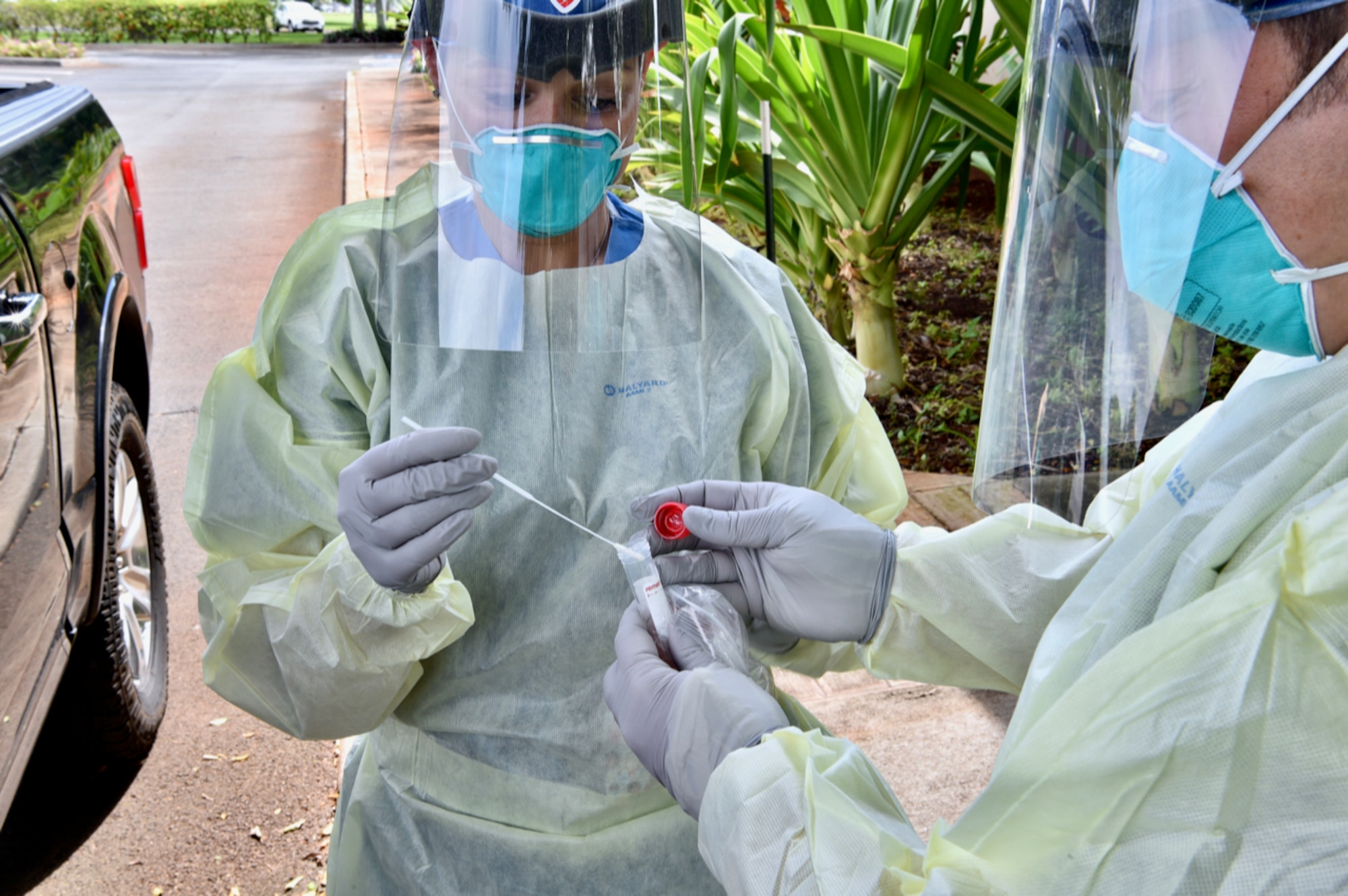 Maj. Nicole Pries, 15th Medical Group COVID-19 Clinic commander, and Tech. Sgt. Christopher Lawson, 15th MDG COVID-19 Clinic flight chief, secure a COVID-19 nasopharyngeal swab test sample during a training session at the 15th MDG, Joint Base Pearl Harbor-Hickam, Hawaii, Oct. 21, 2020. The samples collected during testing must be kept refrigerated while waiting to be transported to the lab for analysis. (U.S. Air Force photo by 2nd Lt. Benjamin Aronson)