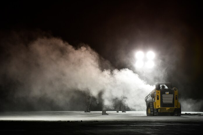 A photo of an Airman using a combat track loader.