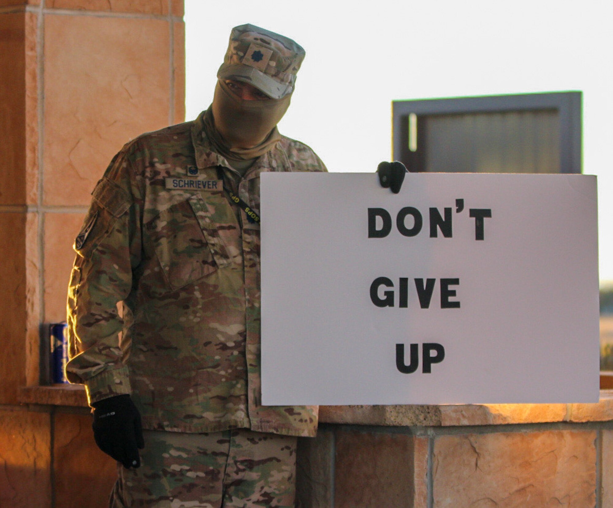 Lt. Col. Michael Schriever, 2nd Space Operations Squadron commander, holds his “Don’t Give Up” sign at the North gate as Airmen and civilians arrive Oct. 30, 2020, at Schriever Air Force Base, Colorado. Thirteen Airmen held signs or handed out candy prior to the morning shift’s duty day. (U.S. Space Force photo by Marcus Hill)