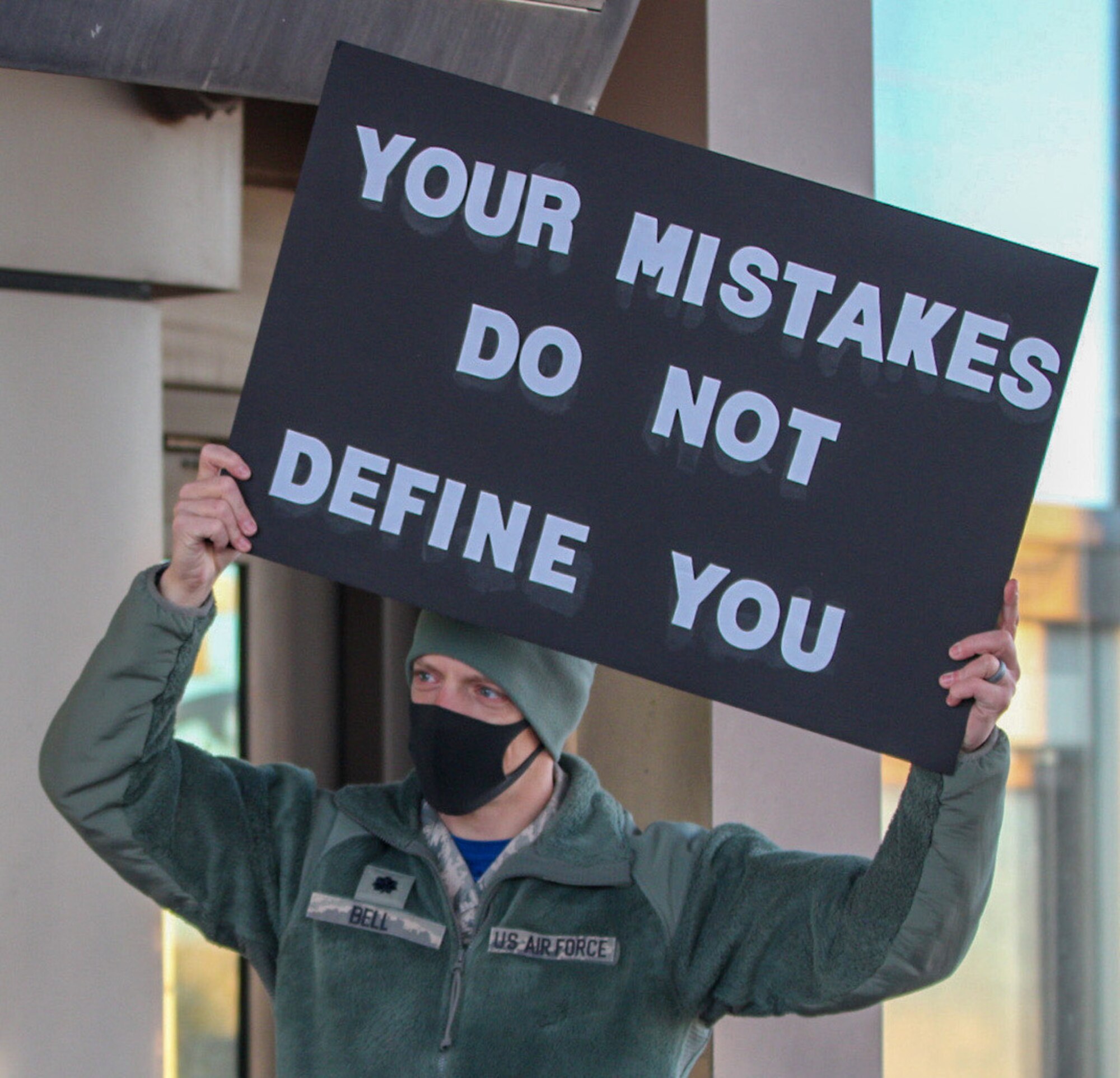 Lt. Col Bryan Bell, 1st Space Operations Squadron commander, displays his sign for users of the North gate to read Oct. 30, 2020, at Schriever Air Force Base, Colorado. Along with an encouraging message, Airmen and civilians received candy as they entered the gate for their duty day. (U.S. Space Force photo by Marcus Hill)