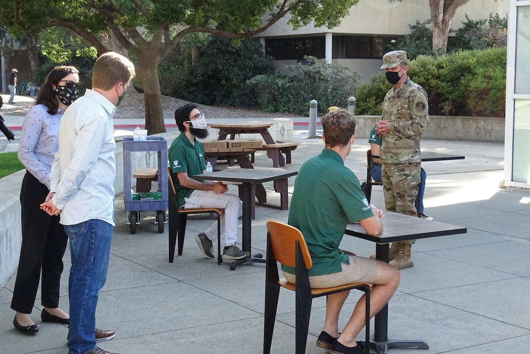 Photo of Maj. Gen. John Shaw meeting Cal Poly CubeSat Lab program students.