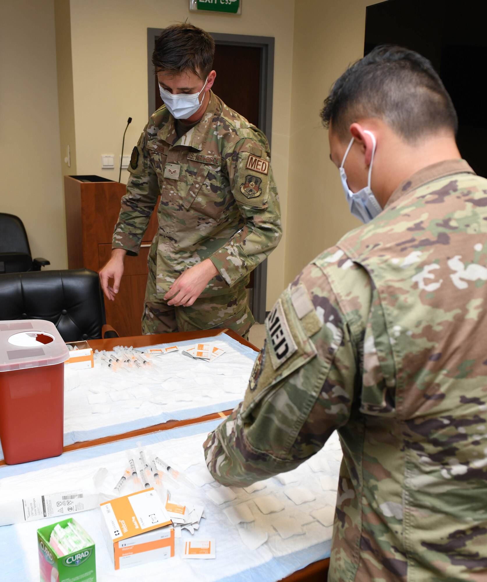 Senior Airman Joshua Zahn and Staff Sgt. Jake Quichocho, medical technicians with the 379th Expeditionary Medical Group, prepare to administer influenza vaccine to Airmen with the 379th Air Expeditionary Wing at Al Udeid Air Base, Qatar, Nov. 3, 2020. Zahn’s initiative to offer vaccination in numerous work centers throughout the wing significantly improves the unit’s mission readiness by preparing service members for the upcoming flu season while preventing confusion between COVID-19 and seasonal flu symptoms. (U.S. Air Force photo by Staff Sgt. Kayla White)