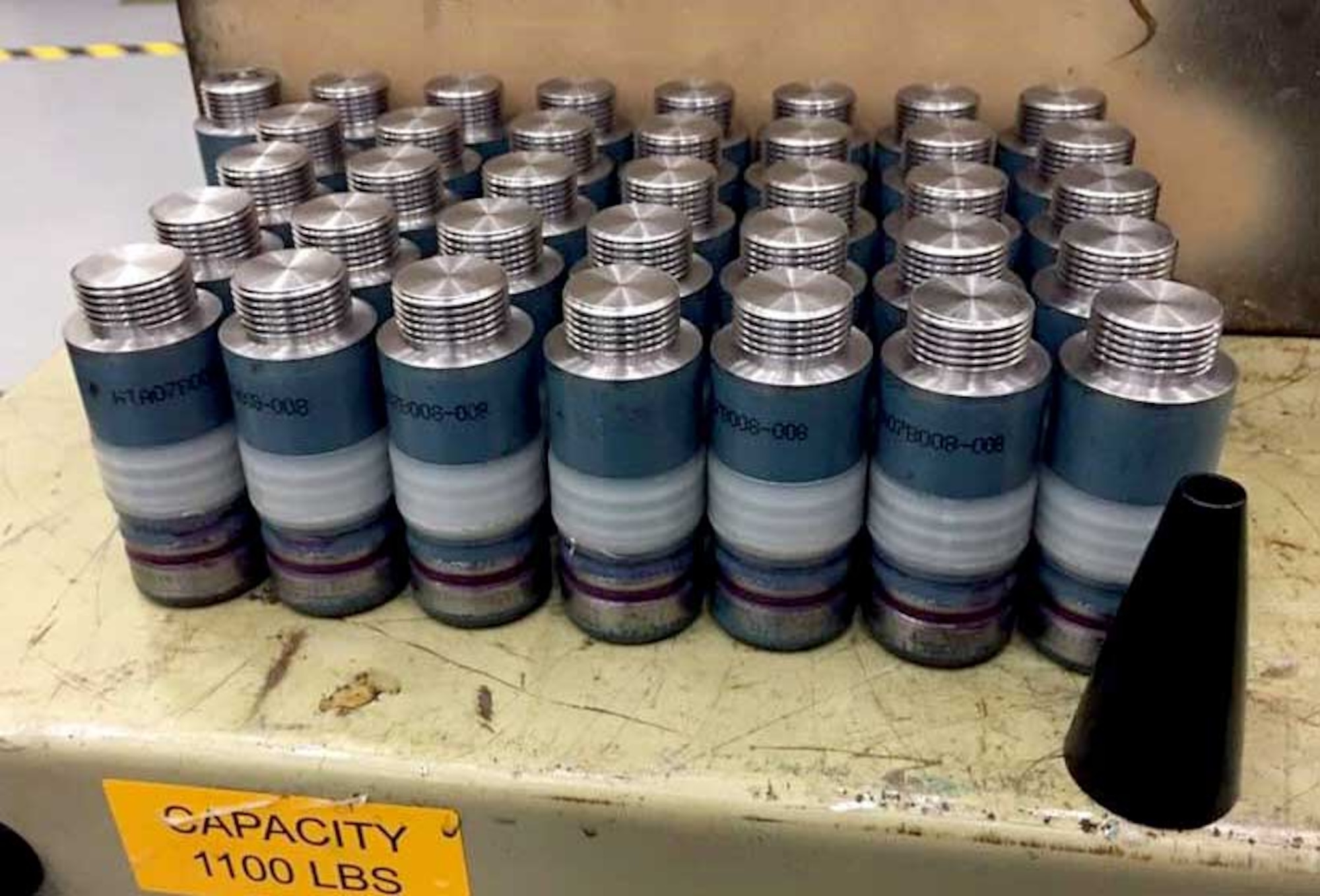 Low-cost training rounds for AC-130 gunships, designed by William Walter, program analyst for Air Force Special Operations Command, are displayed at Hurlburt Field, Florida. The purpose of the LCTR’s is to mimic the ballistic parameters and visual impact of the more expensive high-explosive incendiary combat cartridge. (Courtesy photo)