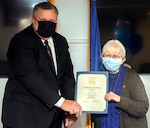 Ronnie Carter (left), director of the Human Resources Division, Air Force Program Executive Office for Business and Enterprise Systems, presents a 50 years of federal service certificate to  Peggy Gast (right), an Air Force Life Cycle Management Center employee at Joint Base San Antonio-Randolph Nov. 2.