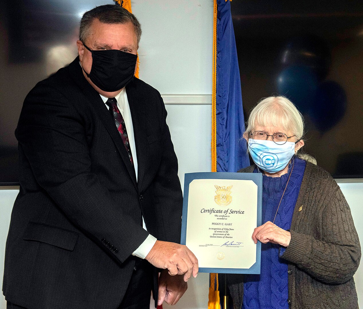 Ronnie Carter (left), director of the Human Resources Division, Air Force Program Executive Office for Business and Enterprise Systems, presents a 50 years of federal service certificate to  Peggy Gast (right), an Air Force Life Cycle Management Center employee at Joint Base San Antonio-Randolph Nov. 2.