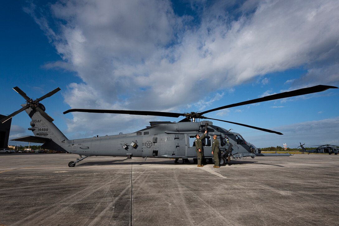 A photo of Airmen inspecting a hoist