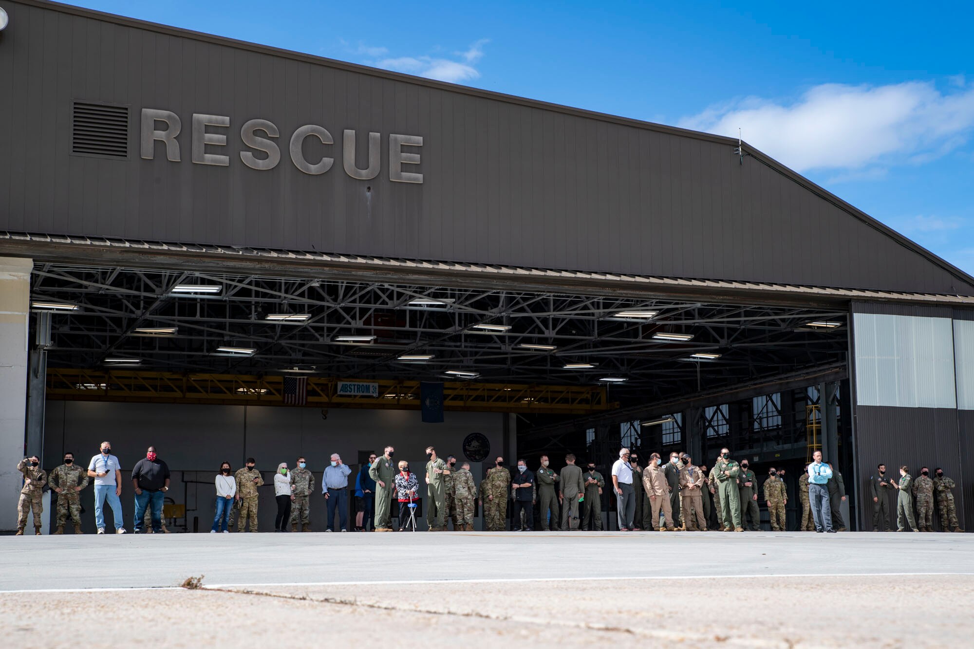 A photo of Airmen waiting for the arrival of a helicopter