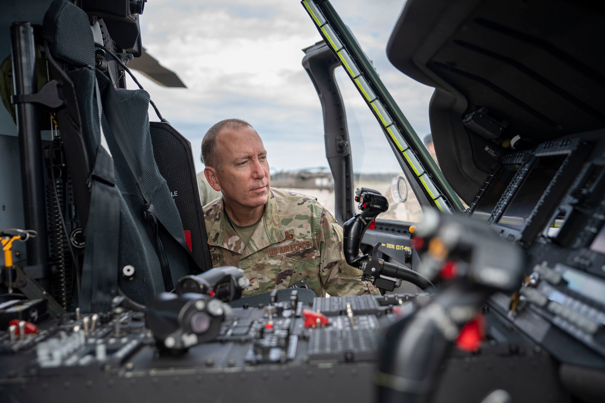 A photo of an Airman looking inside a helicopter