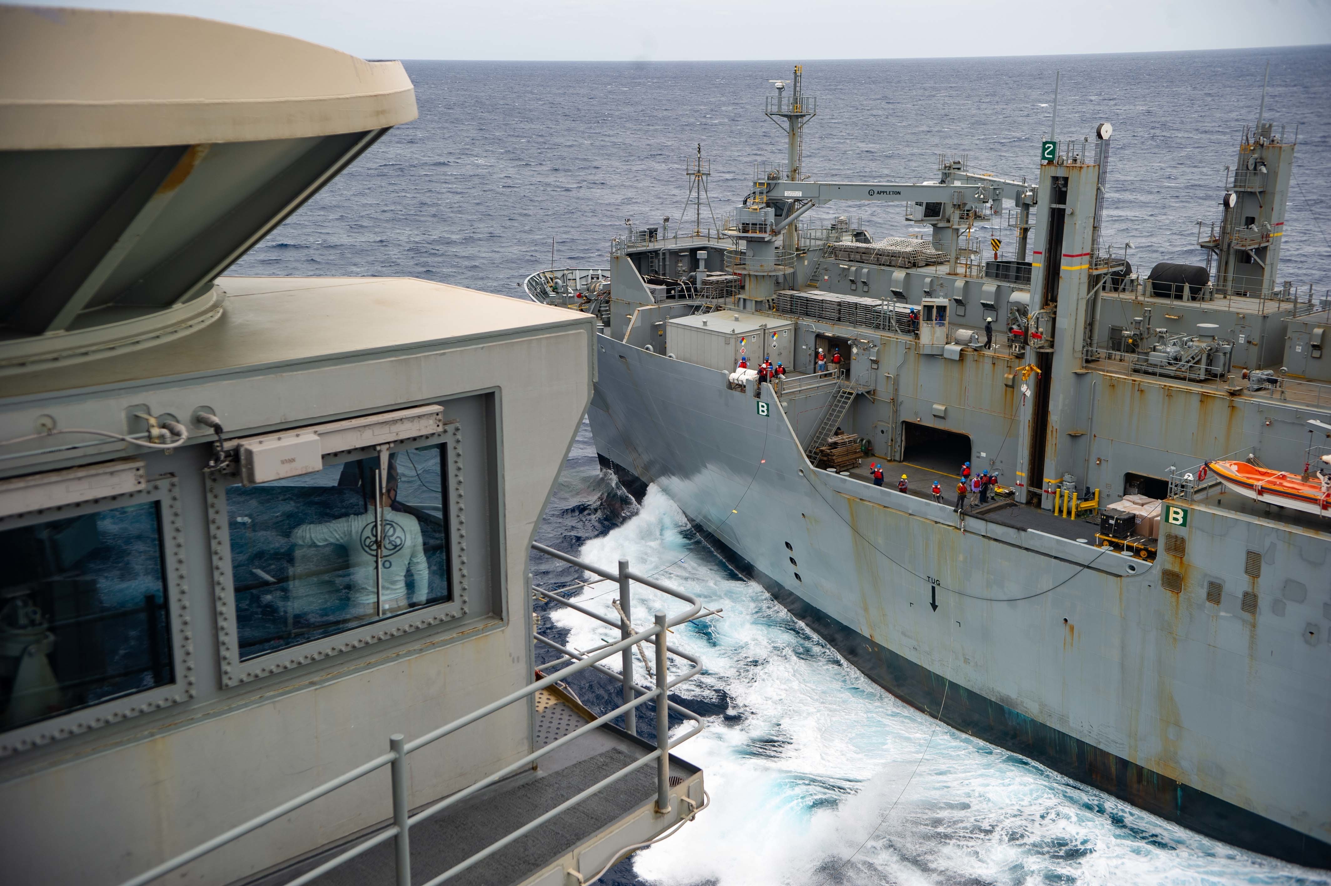 Capt. Matthew Ventimiglia, executive officer of USS Ronald Reagan (CVN 76), observes a replenishment-at-sea with USNS Alan Shepard (T-AKE 3).