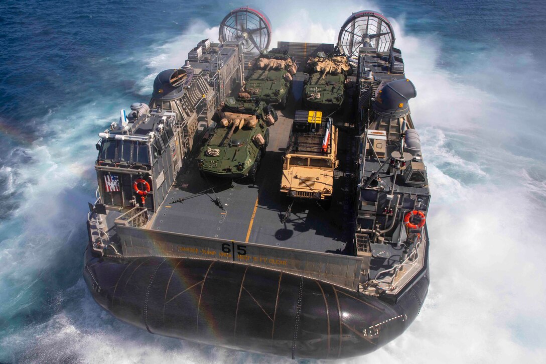 An air-cushioned landing craft travels through waters.