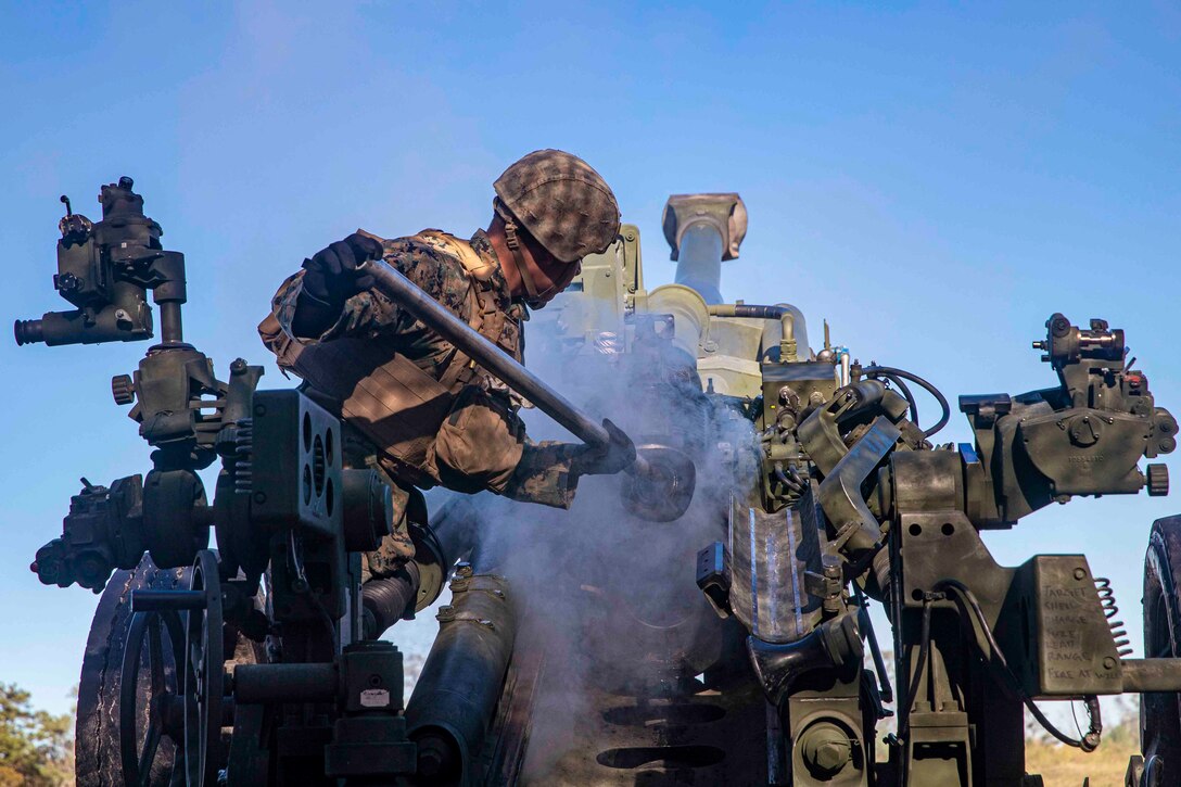 A Marine works on an M777 howitzer.
