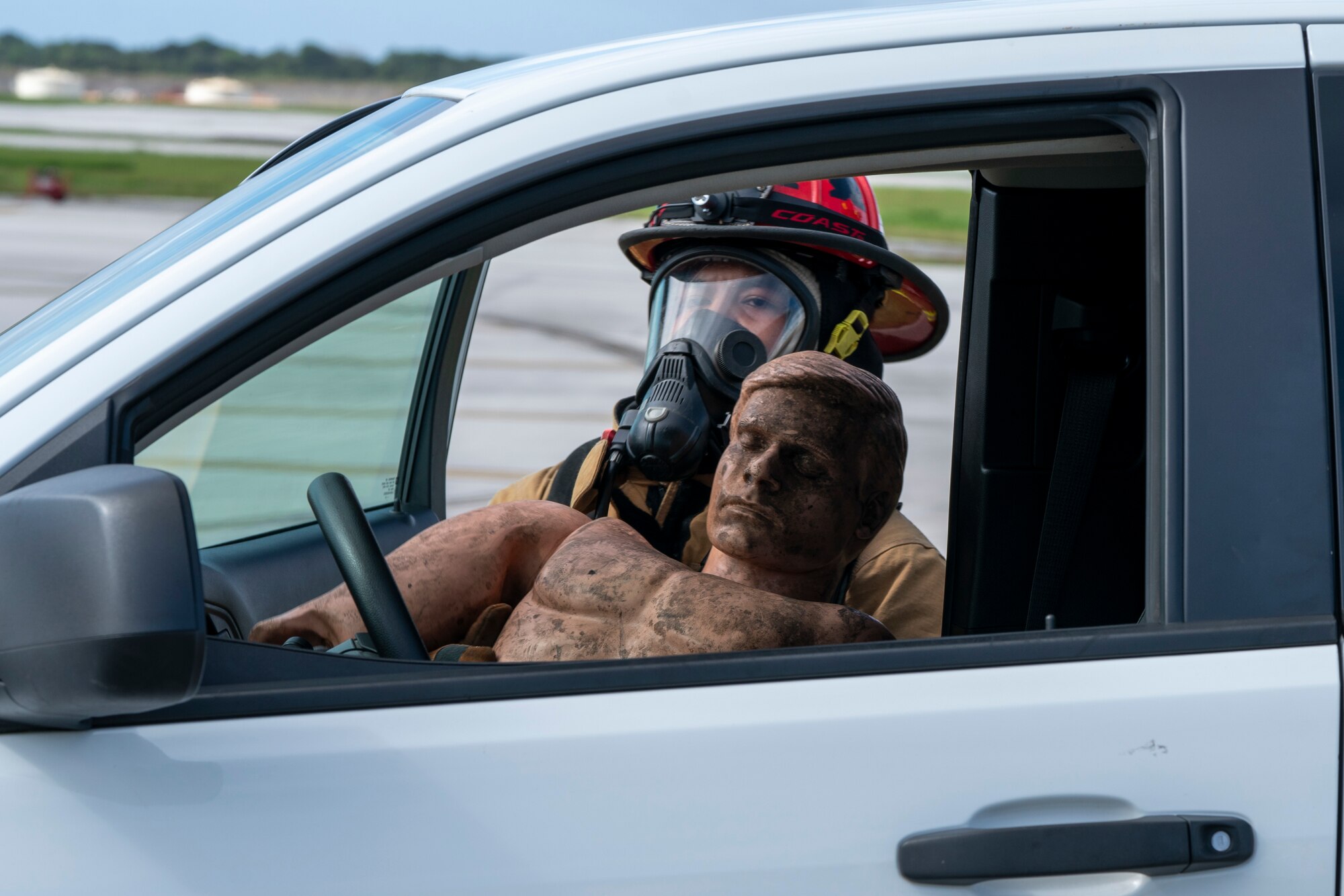 Air Force Staff Sgt. Mykah Rosa, 36th Civil Engineering Squadron crew chief, pulls a mannequin from a simulated burning vehicle during Exercise Sling Stone 21-1 on Nov. 5, 2020 at Andersen Air Force Base, Guam. Exercise Sling Stone is an annual anti-terrorism force protection exercise. The exercise involved multiple training scenarios intended to prepare service members to respond to emergency situations. (U.S. Air Force photo by Tech. Sgt. Esteban Esquivel)