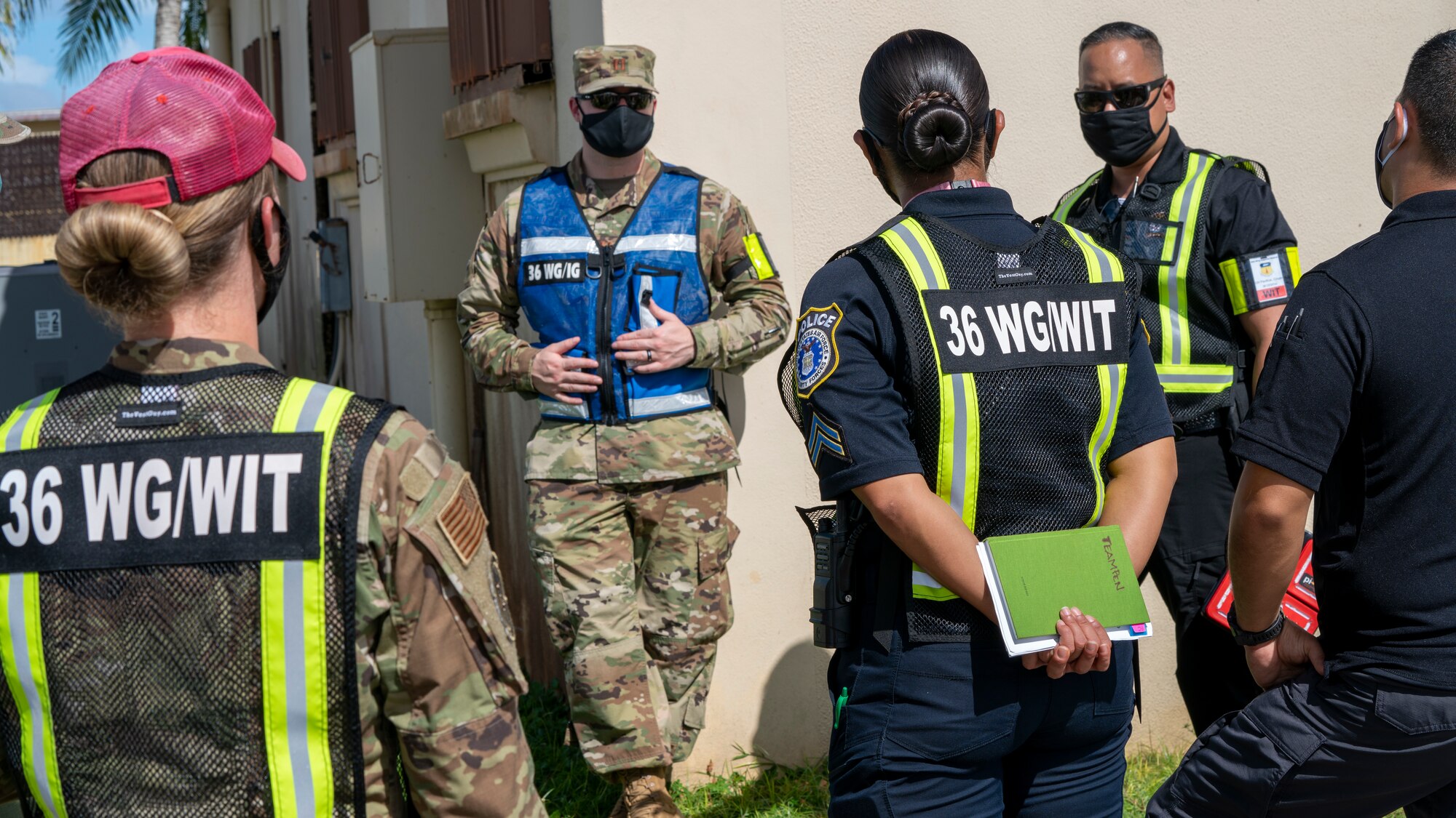 Team Andersen Wing Inspection Team members discuss their evaluations during Exercise Sling Stone 21-1 on Nov. 5, 2020 at Andersen Air Force Base, Guam. Exercise Sling Stone is an annual anti-terrorism force protection exercise. The exercise involved multiple training scenarios intended to prepare service members to respond to emergency situations. (U.S. Air Force photo by Tech. Sgt. Esteban Esquivel)