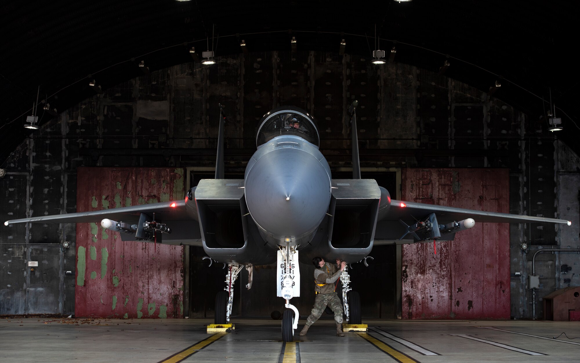 U.S. Air Force Senior Airman Dylan Tyler, 748th Aircraft Maintenance Squadron weapons load crew member, performs pre-flight checks on an F-15C Eagle prior to take-offs in support of exercise Crimson Warrior at Royal Air Force Lakenheath, England, Nov. 4, 2020. Multi-domain integration exercises like Crimson Warrior strengthen NATO interoperability and test high-end capabilities in a contested, degraded, and operationally limited environment. (U.S. Air Force photo by Airman 1st Class Jessi Monte)