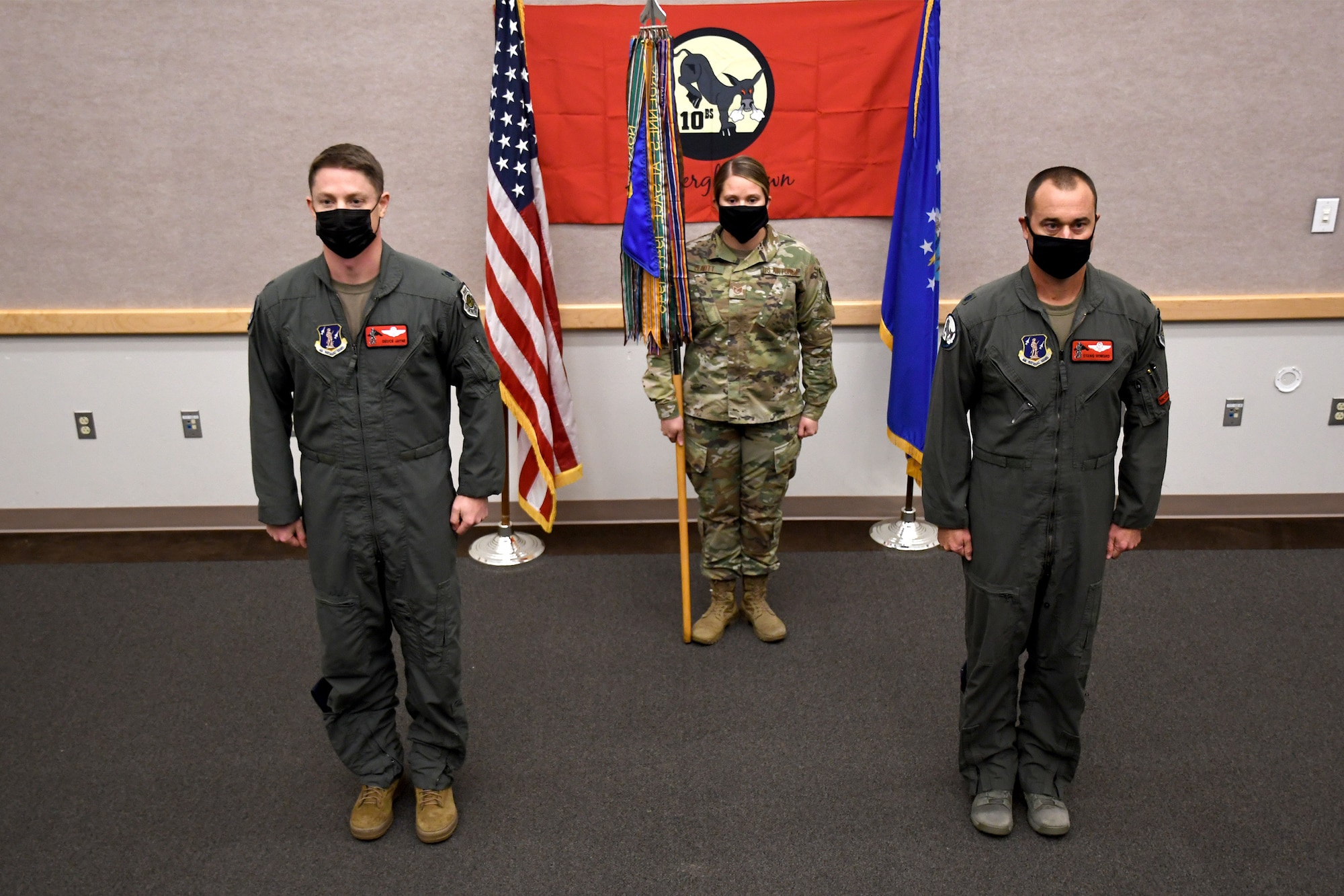 110th Bomb Squadron leadership stands at attention during an assumption of command ceremony, Oct. 24, 2020, at The Technical Sergeant Luke C.A. Ford Auditorium on Whiteman Air Force Base, Mo. Lt. Col. Matthew Howard (right) took command of the squadron after Lt. Col. Luke Jayne (left) was promoted to 131st Operations Group Commander earlier this year. (U.S. Air National Guard photo by Staff Sgt. Joshua Colligan)