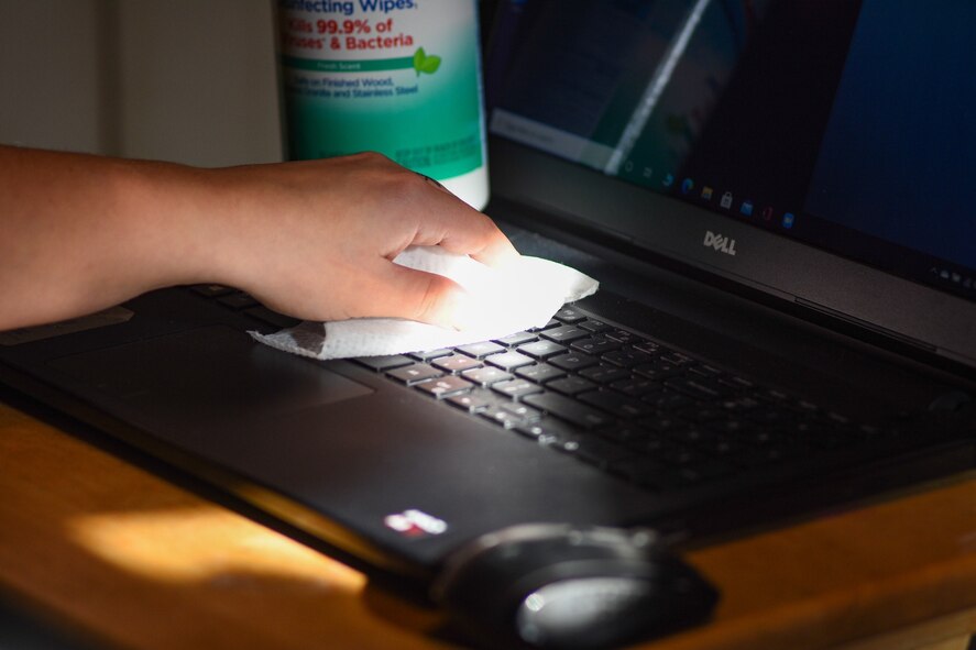 A Hanscom Air Force Base, Mass., employee disinfects their keyboard at the end of the duty day Nov. 5. Officials from the 66th Medical Squadron recommend personnel clean commonly-used items to help prevent the spread of COVID-19. (U.S. Air Force photo by Mark Herlihy)