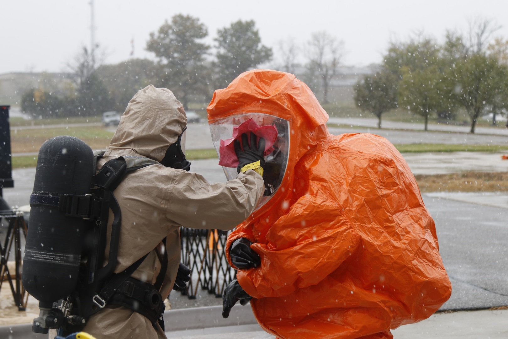 Photo: Staff Sgt. Corey Simmons, decontamination officer, 63rd Civil Support Team, Oklahoma National Guard, wipes down a Level A hazard suit of Sgt. Christina Burgess, surveyor, also a 63rd Civil Support Team member, during decontamination after a mission in the Boone County Fire Protection District, Columbia, Missouri, Oct. 26, 2020. The 63rd Civil Support Team conducted a four-day joint training exercise to evaluate their response in supporting civil authorities at a domestic Chemical, Biological, Radiological, Nuclear, and High Yield Explosive (CBRNE) incident site. CBRNE agents advise on response measures and assist with appropriate requests for additional support. (Oklahoma Army National Guard Photo by Spc. Caleb Stone)