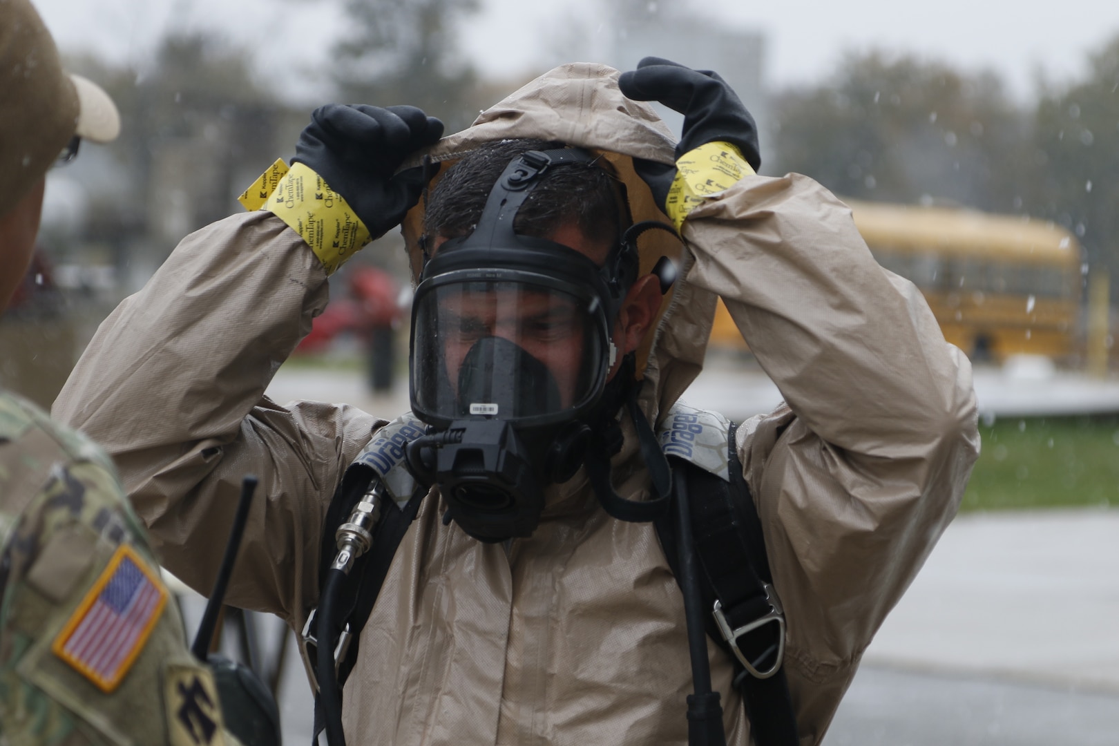 Photo: Staff Sgt. Corey Simmons, decontamination officer with the 63rd Civil Support Team, Oklahoma National Guard, dons a safety suit in preparation to decontaminate the survey team after they have completed their mission in the Boone County Fire Protection District, Columbia, Missouri, Oct. 26, 2020.

The 63rd Civil Support Team conducted a four-day joint training exercise to evaluate their response in supporting civil authorities at a domestic Chemical, Biological, Radiological, Nuclear, and High Yield Explosive (CBRNE) incident site. CBRNE agents advise on response measures and assist with appropriate requests for additional support. (Oklahoma Army National Guard Photo by Spc. Caleb Stone)