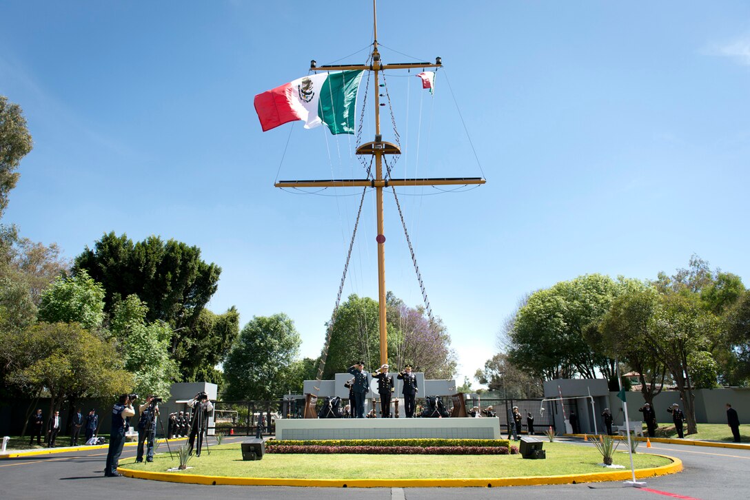 A flag flies above a memorial.