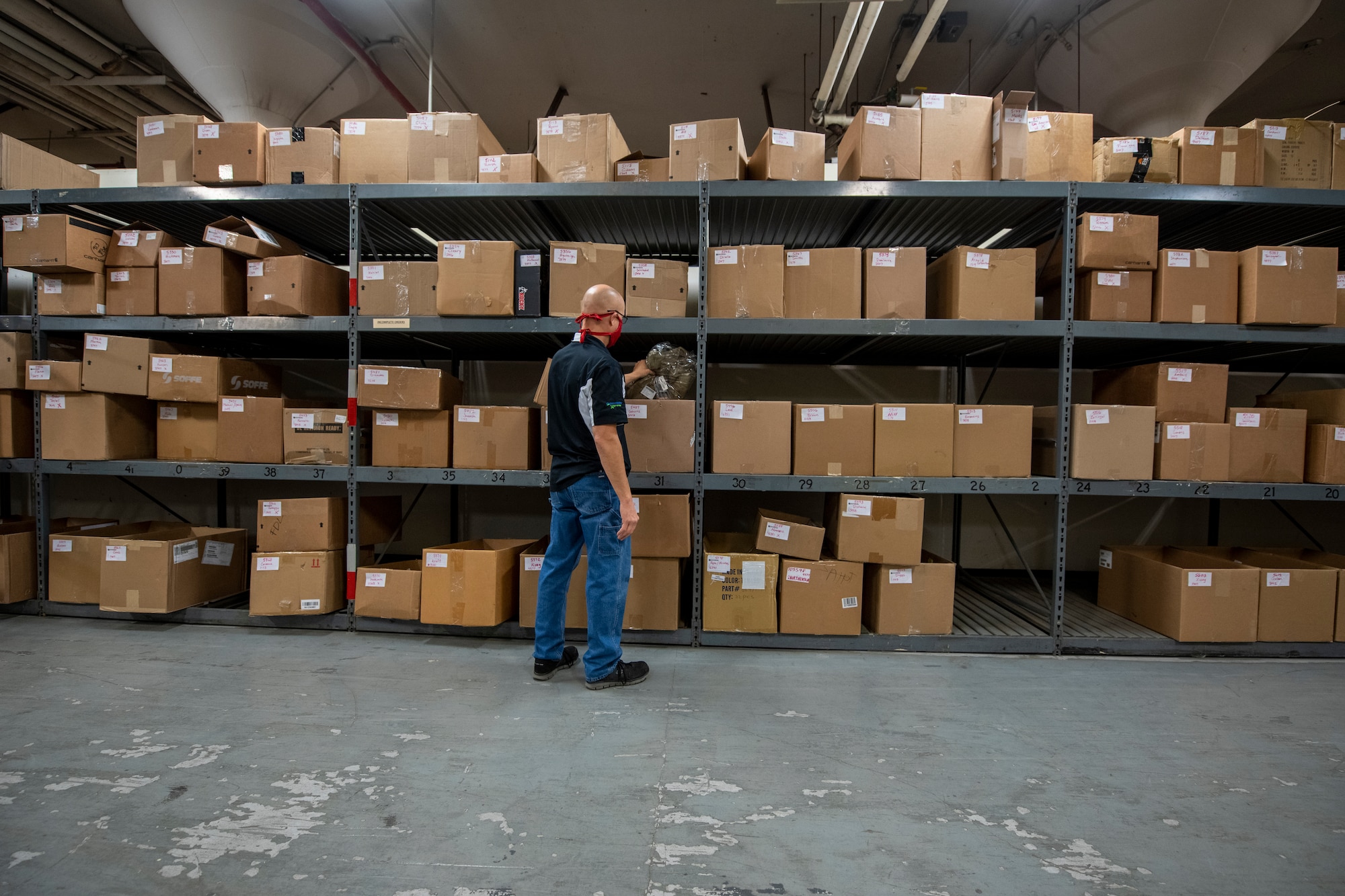 Man looks through boxes