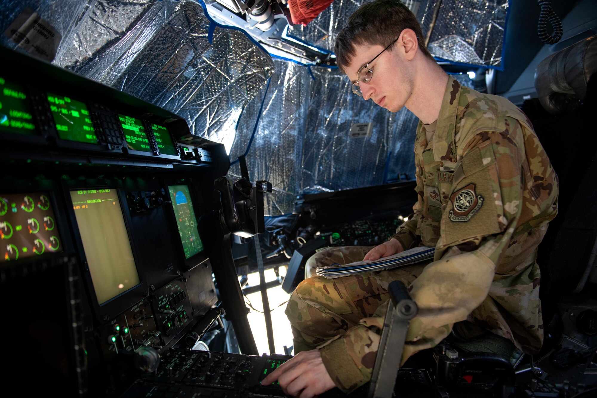 Man siting in pilot seat running checks on flight instruments