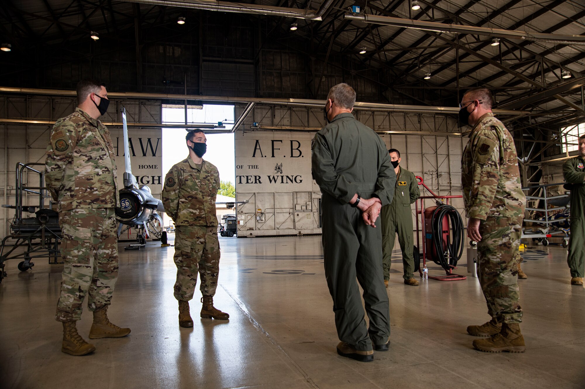 A photo of Airmen standing having a conversation.