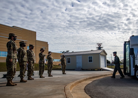 a photo of Airmen saluting a General.