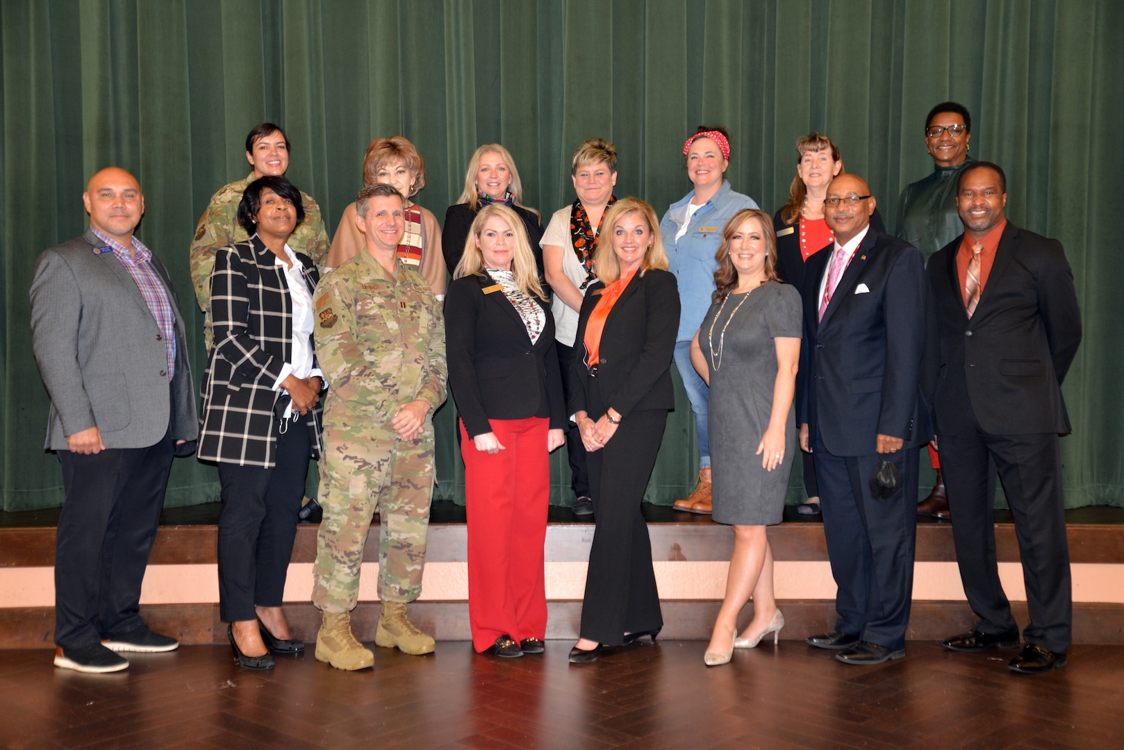 Bernadette Gast (center front, in red), 502nd Air Base Wing mission partner protocol advisor/liaison, and Kellie Washburn (in black), 502nd ABW chief of protocol, surrounded by Joint Base San Antonio protocol directors, chiefs, protocol leads, and those working in protocol offices as an additional duty during the mission partner “Protocol Huddle,” at the Gateway Club, JBSA-Lackland, Oct. 30. (U.S. Air Force photo by Minnie Jones)