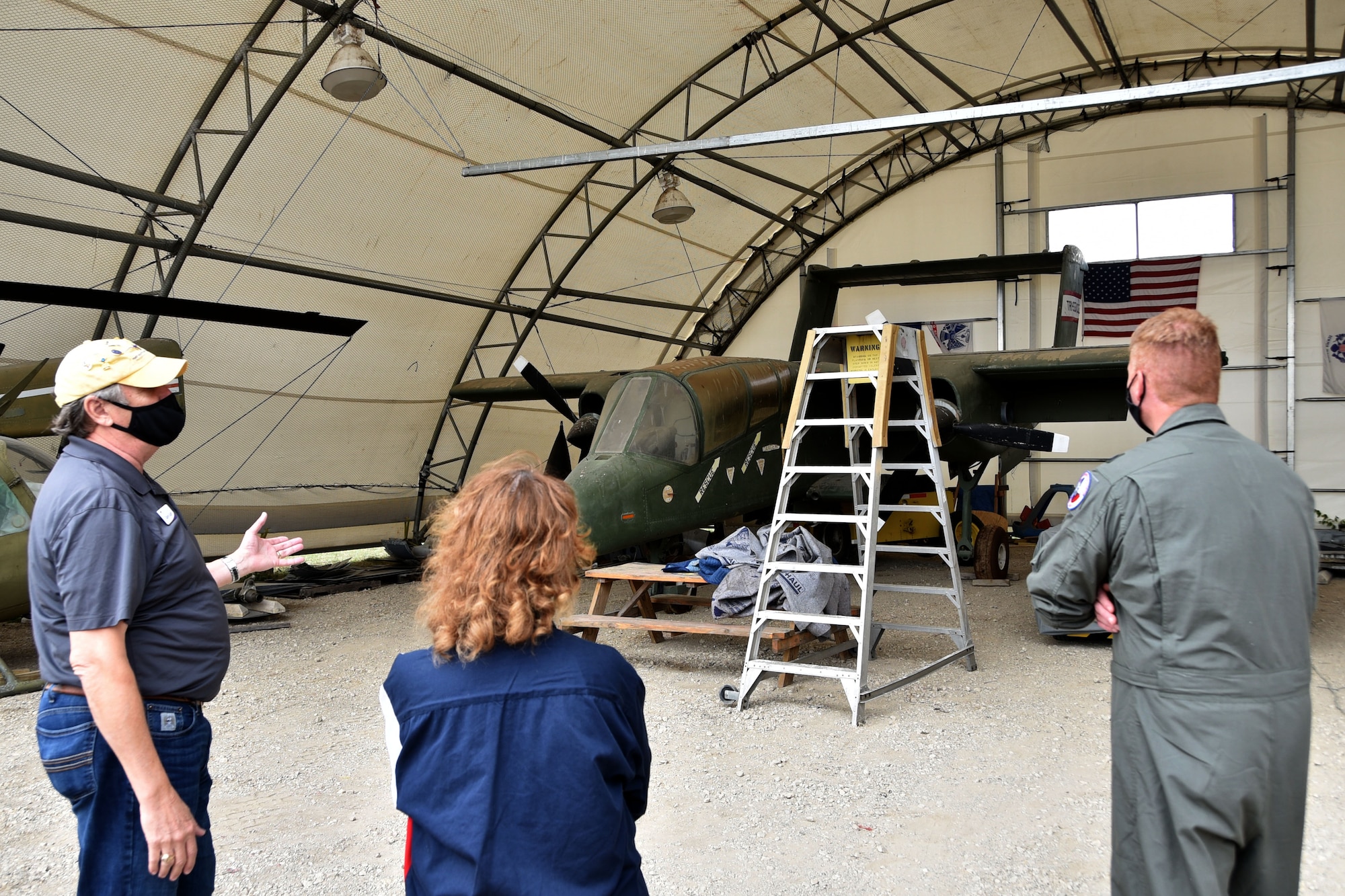 Garry Goff, Fort Worth Aviation Museum tour guide, introduces the OV-10 Bronco mock-up to Maritta Sumner, Fort Worth Air Power Council vice chairman, and Maj. Ryan “Rojo” Busbey, 24th Fighter Squadron commander, at the FWAM in Fort Worth, Texas on November 6, 2020. This visit to the FWAM connected multiple generations of military aviators, who each shared their experiences. (U.S. Air Force photo by Staff Sgt. Randall Moose)