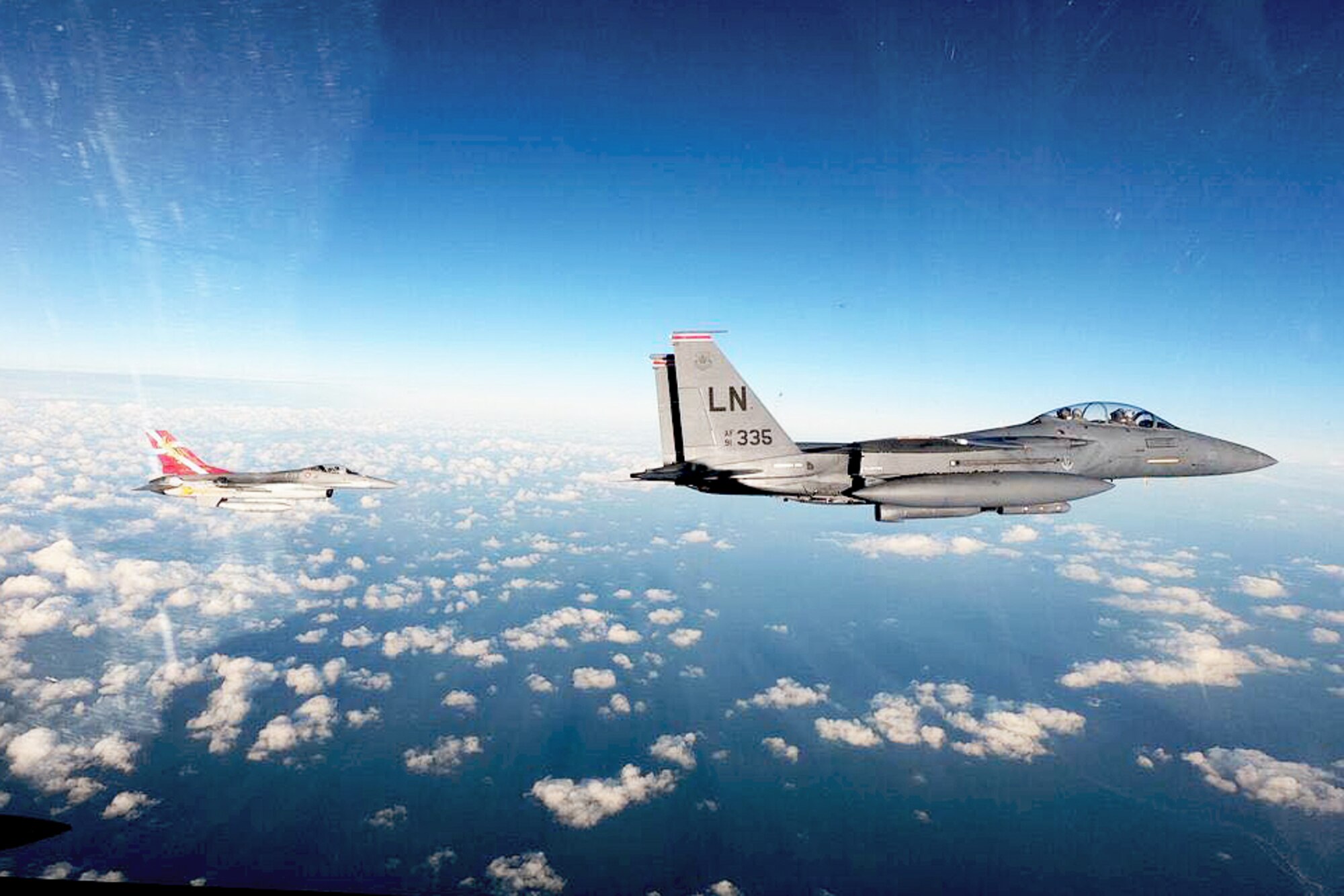 An F-15E Strike Eagle assigned to the 48th Fighter Wing flies in formation with an F-16 Fighting Falcon assigned to the Danish Special Operation Forces during a combined readiness exercise in the Baltic region, Nov 2, 2020. Exercises and engagements in the European area of responsibility demonstrate U.S. commitment to the security and stability in this region through operationalizing agility-based war-fighting concepts. (U.S. Air Force photo by Senior Airman Shanice Ship)