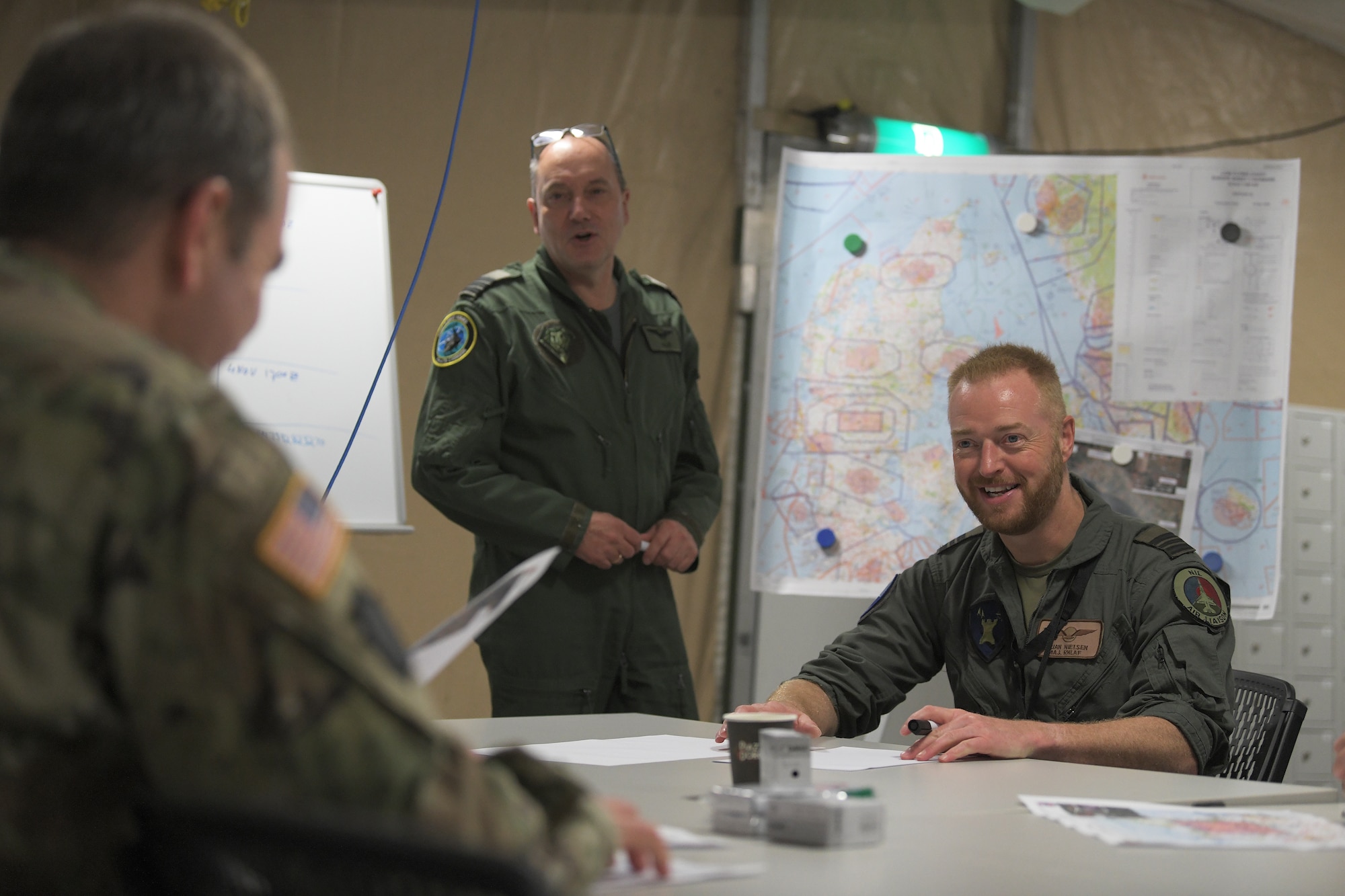 Participants of a combined readiness exercise in the Baltic region conduct a mission briefing at Aalborg Air Base, Denmark, Oct. 31, 2020. The exercise enhances the proficiency of multinational forces to counter military aggression and coercion by sharing responsibilities for common defense. (U.S. Air Force photo by Senior Airman Shanice Ship)
