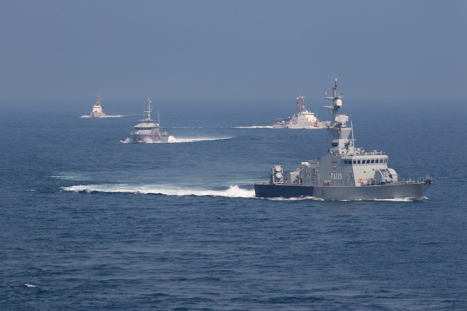 201105-N-N0146-1589 ARABIAN GULF (Nov. 05 2020) The guided-missile destroyer USS Ralph Johnson (DDG 114), Kuwait Naval Force missile boat Al- Saadi (P 3723), Kuwait Coast Guard fast patrol boat Marzoug (P 314) and U.S. Coast Guard patrol boats USCGC Aquidneck (WPB 1309) and USCGC Monomoy (WPB 1326) steam in formation during a joint maritime security patrol exercise in the Arabian Gulf, Nov. 5. Ralph Johnson is part of Nimitz Carrier Strike Group and is deployed to the U.S. 5th Fleet area of operations to ensure maritime stability and security in the Central Region, connecting the Mediterranean and Pacific through the Western Indian Ocean and three critical chokepoints to the free flow of global commerce.