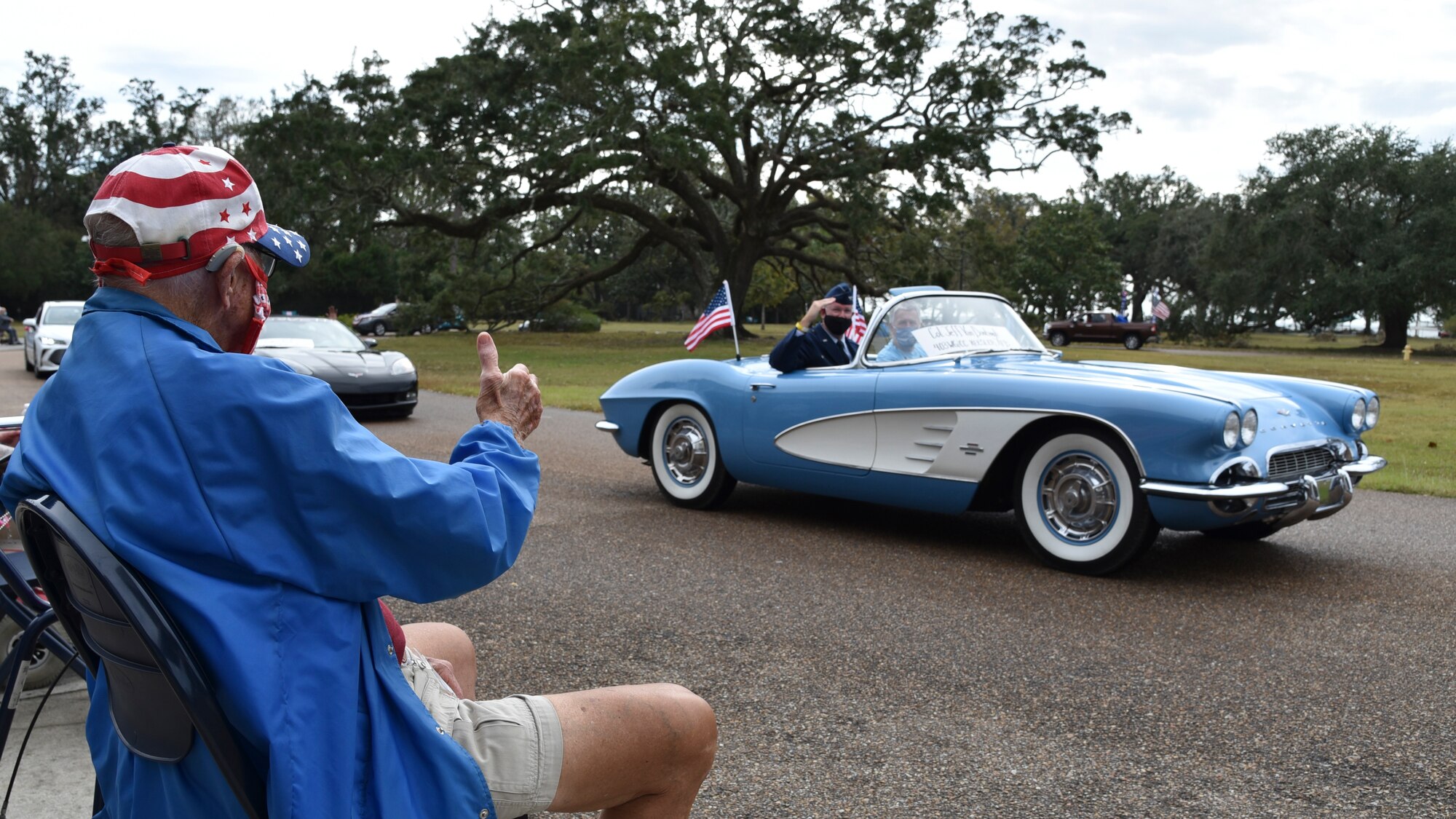 Col. Jeffrey A. Van Dootingh, 403rd Wing commander, waves at veterans and staff gathered for the Gulf Coast Veterans Day Roll-Thru and Wave event at the Armed Forces Retirement Home, Gulfport, Mississippi, Nov. 7, 2020. The celebration featured a parade of vintage automobiles, first responder vehicles and a C-130J Super Hercules flyover by the 815th Airlift Squadron. (U.S. Air Force photo by Tech. Sgt. Michael Farrar)