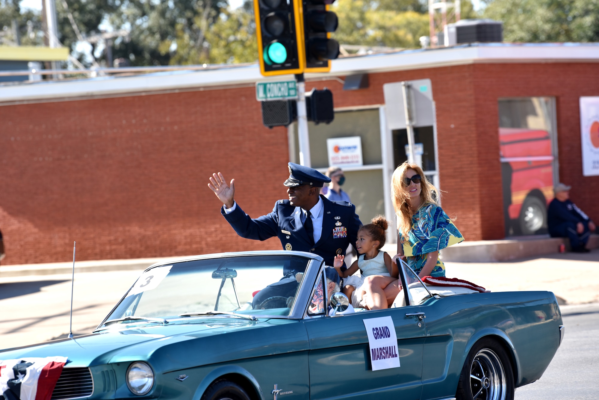 U.S. Air Force Col. James Finlayson, 17th Training Wing vice commander, and family wave from the grand marshal's car during the Veterans Day Parade in downtown San Angelo, Texas, Nov. 7, 2020. The theme of the parade this year was “Welcome Home Vietnam Veterans” honoring those who may have not received a warm welcome after returning from combat. (U.S. Air Force Photo by Staff Sgt. Seraiah Wolf)