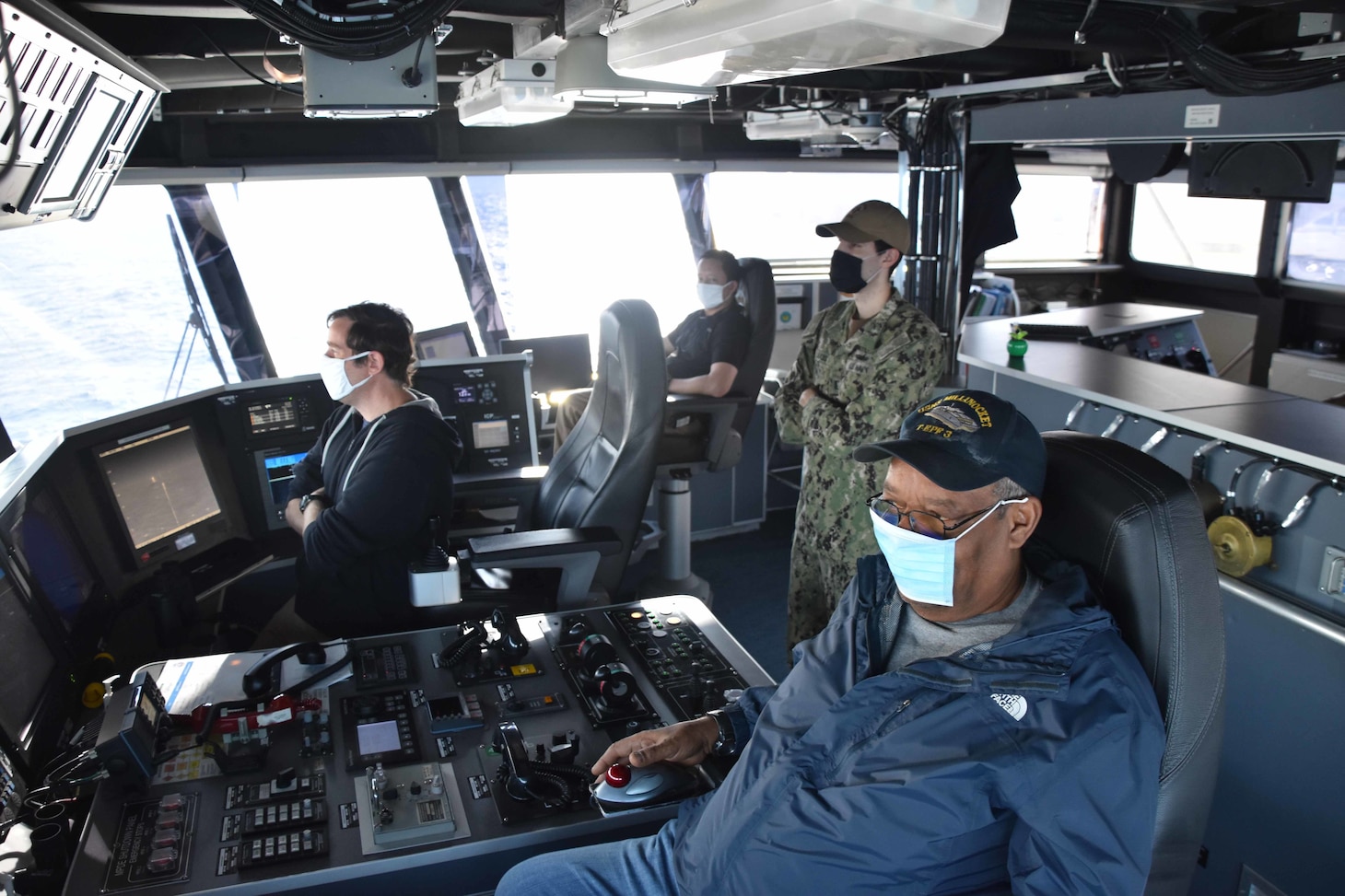 Sailors aboard the expeditionary fast transport ship USNS Millinocket (T-EPF 3) navigate the ship from the bridge.